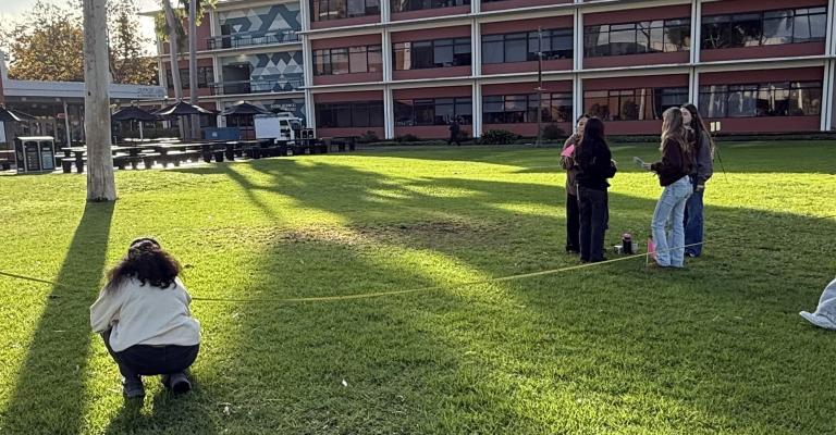 Calculus students measuring distances on the quad